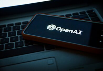 a cell phone sitting on top of a laptop computer