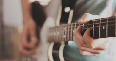 person playing electric guitar