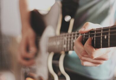 person playing electric guitar