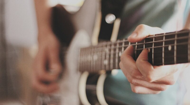 person playing electric guitar